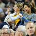 Michigan fans Charlotte Hauptman, 9, and Sophia Kunisaki, 9, both of Ann Arbor, dance while standing on their seats during a time out during the second half against North Carolina State at Crisler Center on Tuesday night. Melanie Maxwell I AnnArbor.com